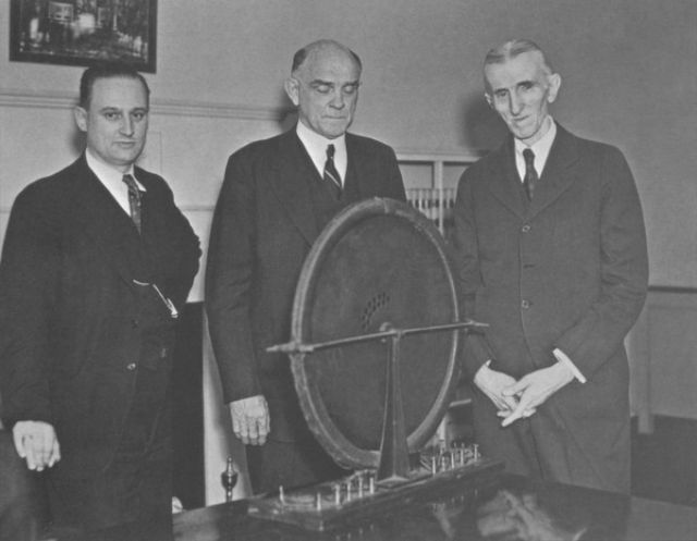 John T. Morris, Victor Beam, and Tesla pose with the discovered alternator.