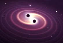 दो ब्लैक होल आपस में टकराकर गुरुत्वाकर्षण तरंगें उत्पन्न करते हुए, एक कलात्मक चित्रण।