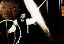 Nikola Tesla demonstrates wireless power transmission in his laboratory.